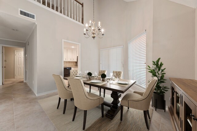 3708 Masters Ct, League City, TX 77573 - dining room with a chandelier, light tile patterned floors, baseboards, crown molding, and a high ceiling
