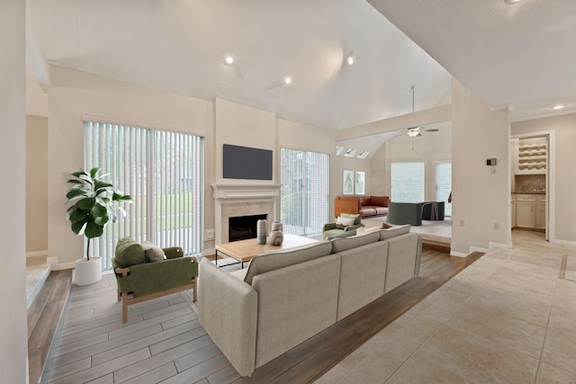 3708 Masters Ct, League City, TX 77573 - living area featuring a fireplace, ceiling fan, baseboards, light wood-style flooring, and recessed lighting