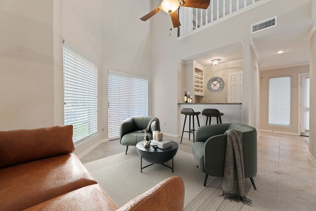 3708 Masters Ct, League City, TX 77573 - living area with baseboards, ceiling fan, a high ceiling, crown molding, and bar area