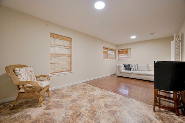 interior space featuring baseboards, stone finish flooring, visible vents, and recessed lighting