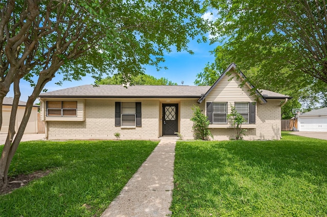 view of front of house with a front yard and brick siding