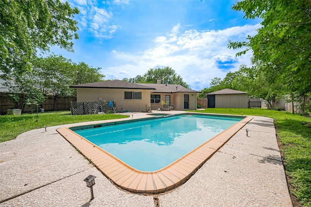 view of swimming pool with a patio, a fenced in pool, an outbuilding, a lawn, and a fenced backyard