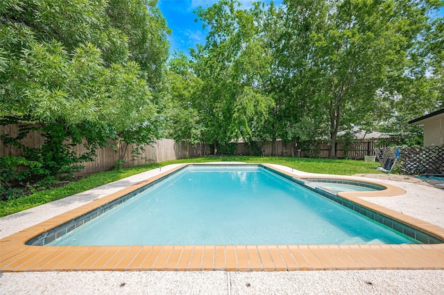 view of pool with a fenced in pool, a lawn, an in ground hot tub, and a fenced backyard