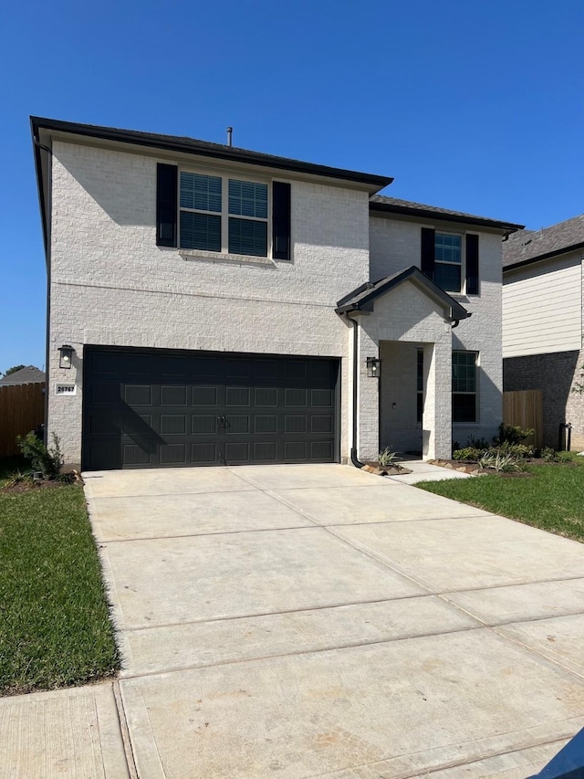 26767 Grandiflora Dr, Magnolia, TX 77355 - view of front of property featuring a garage, brick siding, driveway, and fence