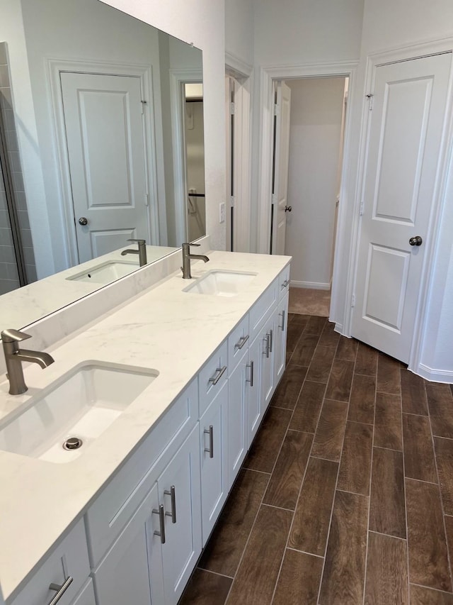 26767 Grandiflora Dr, Magnolia, TX 77355 - bathroom featuring baseboards, a sink, and wood finish floors