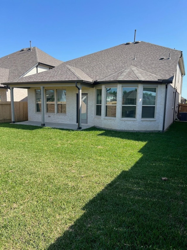 26767 Grandiflora Dr, Magnolia, TX 77355 - rear view of house with a yard, fence, central AC unit, and roof with shingles