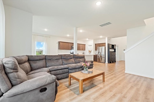 living area with visible vents, recessed lighting, and light wood finished floors