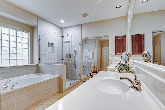 bathroom with a garden tub, a shower stall, recessed lighting, vanity, and tile patterned flooring