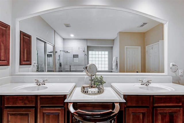 bathroom featuring a stall shower and vanity