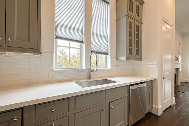 5101 Allen St, Houston, TX 77007 - kitchen with stainless steel dishwasher, a sink, glass insert cabinets, and light countertops