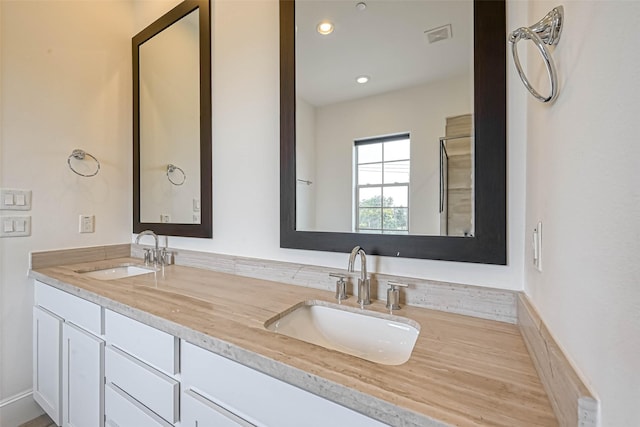 5101 Allen St, Houston, TX 77007 - bathroom featuring double vanity and recessed lighting