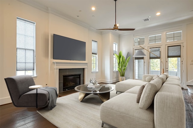 5101 Allen St, Houston, TX 77007 - living area with wood-type flooring, a tiled fireplace, recessed lighting, ceiling fan, and baseboards