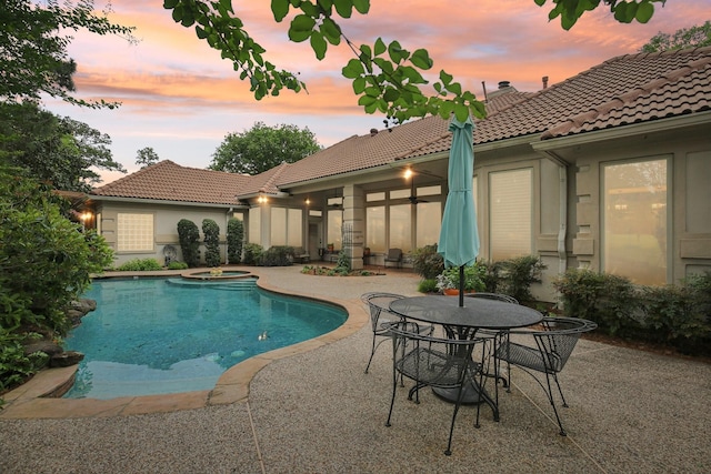 6230 Pebble Beach Dr, Houston, TX 77069 - pool at dusk with a patio and a pool with connected hot tub