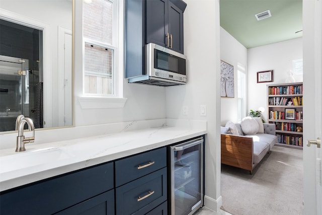 4504 Yupon St, Houston, TX 77006 - bar featuring wine cooler, a sink, stainless steel microwave, and healthy amount of natural light