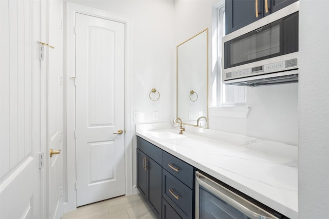 4504 Yupon St, Houston, TX 77006 - bathroom featuring beverage cooler, vanity, and tile patterned floors