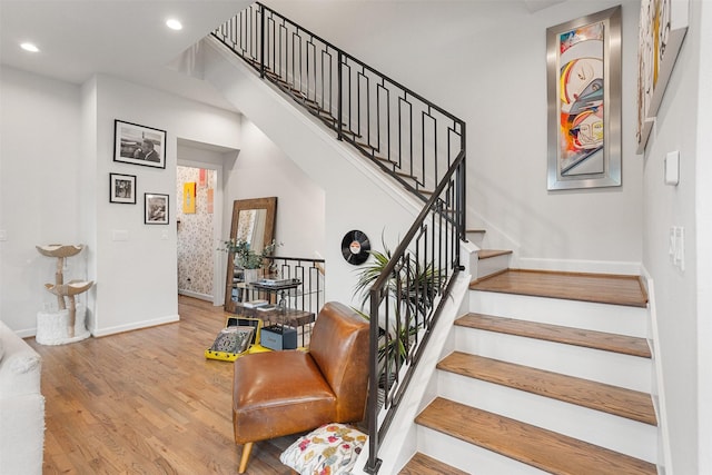 4504 Yupon St, Houston, TX 77006 - stairs with baseboards, wood finished floors, and recessed lighting