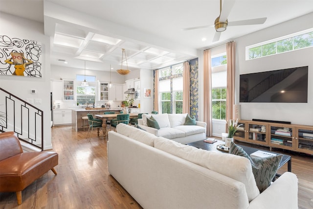 4504 Yupon St, Houston, TX 77006 - living area with coffered ceiling, wood finished floors, a ceiling fan, stairway, and beamed ceiling