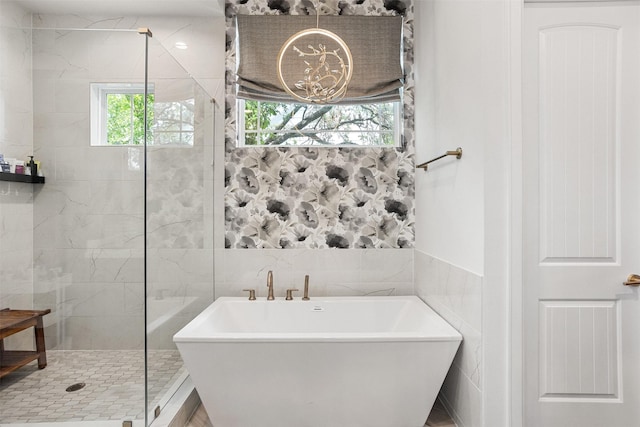 4504 Yupon St, Houston, TX 77006 - bathroom featuring a freestanding tub, a stall shower, and tile walls
