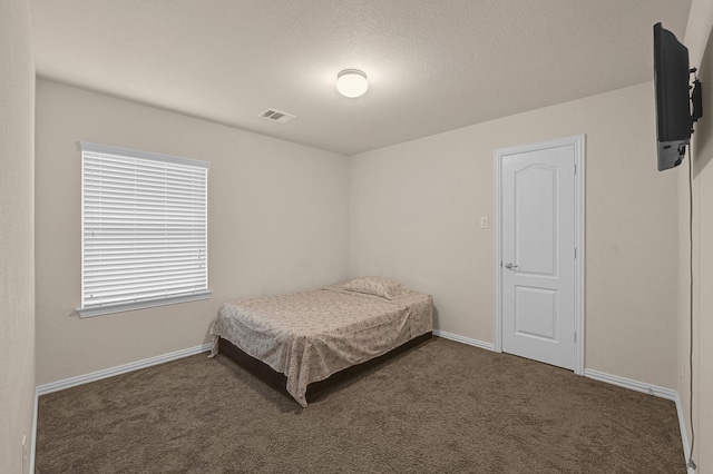 carpeted bedroom featuring visible vents and baseboards