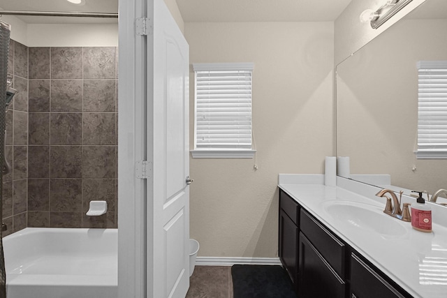 full bathroom featuring baseboards, vanity, and tub / shower combination