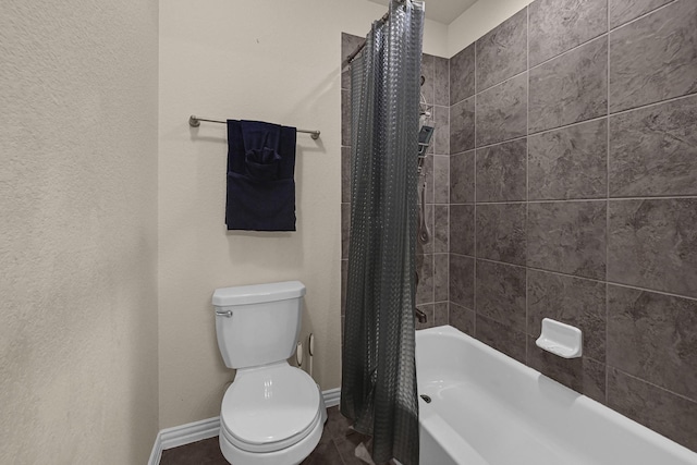 full bathroom with toilet, shower / tub combo, baseboards, and tile patterned flooring