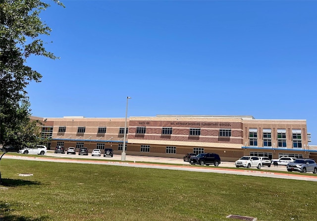 view of property featuring uncovered parking