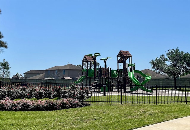 communal playground with fence and a lawn