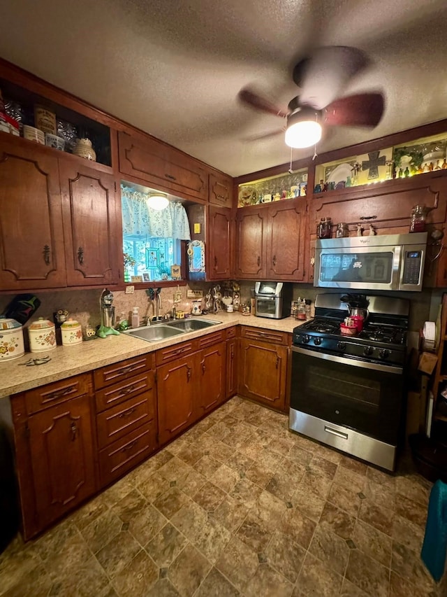 447 Fm 2540 N, Van Vleck, TX 77482 - kitchen featuring stainless steel appliances, a sink, a textured ceiling, light countertops, and ceiling fan