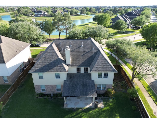aerial view of property and surrounding area with a nearby body of water