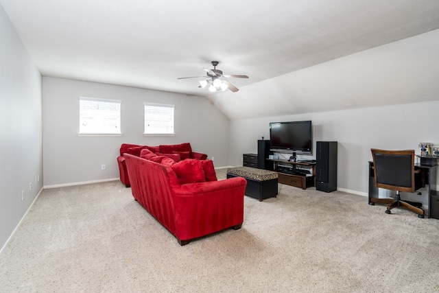 carpeted living area with a ceiling fan, baseboards, and lofted ceiling