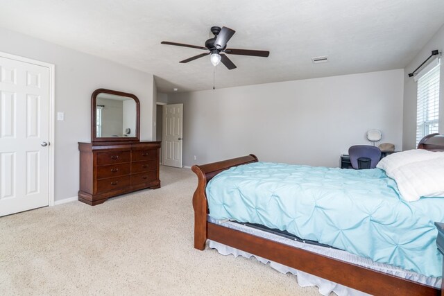 carpeted bedroom featuring a ceiling fan and baseboards