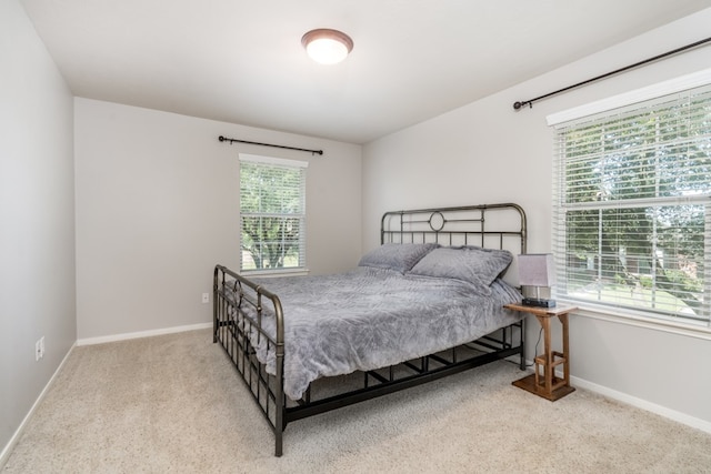 carpeted bedroom with baseboards