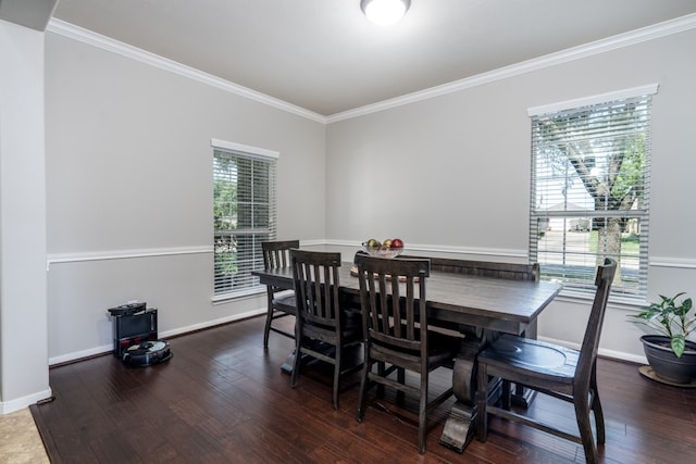 dining space with crown molding, wood finished floors, and baseboards