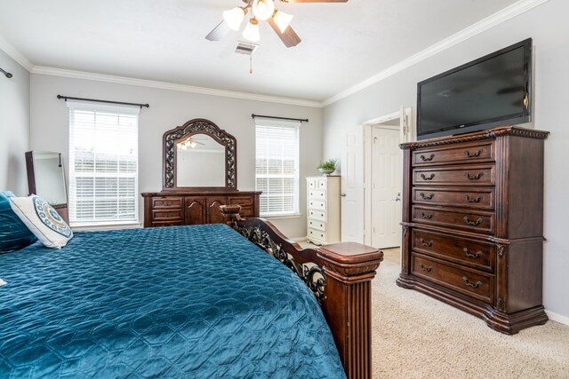 bedroom with ornamental molding, light colored carpet, and ceiling fan