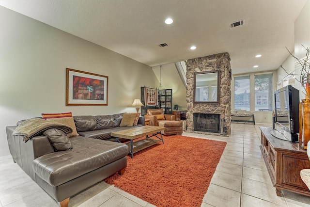 living area featuring visible vents, a stone fireplace, recessed lighting, and light tile patterned floors