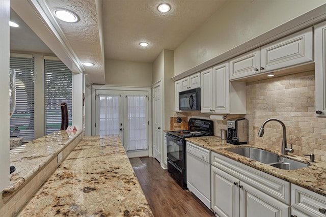 kitchen featuring a sink, a textured ceiling, dark wood finished floors, black appliances, and french doors