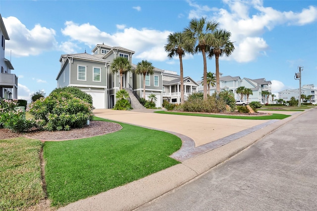 20710 E Sunset Bay Dr, Galveston, TX 77554 - view of front facade featuring driveway, a garage, a front yard, and a residential view
