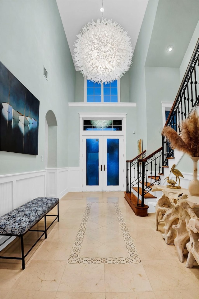 20710 E Sunset Bay Dr, Galveston, TX 77554 - entryway featuring visible vents, stairs, arched walkways, french doors, and wainscoting