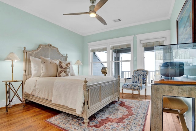 20710 E Sunset Bay Dr, Galveston, TX 77554 - bedroom with baseboards, visible vents, crown molding, and wood finished floors