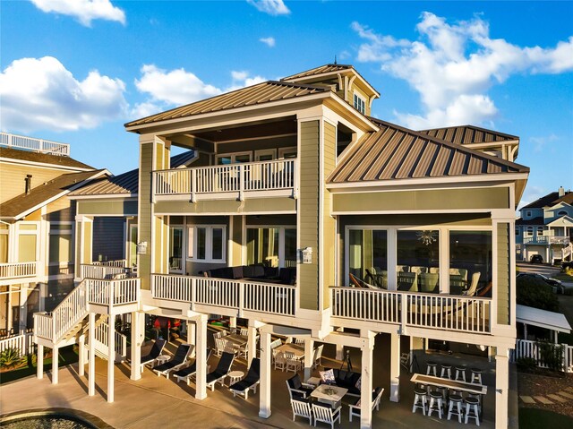 20710 E Sunset Bay Dr, Galveston, TX 77554 - rear view of house with a standing seam roof and metal roof