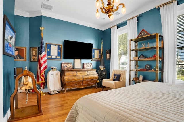 20710 E Sunset Bay Dr, Galveston, TX 77554 - bedroom with visible vents, an inviting chandelier, crown molding, and wood finished floors