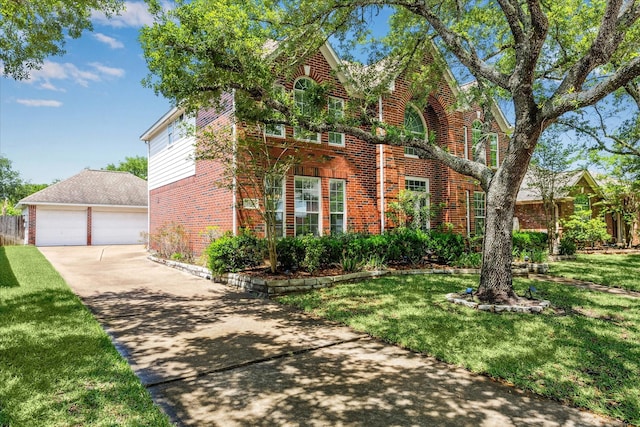 view of front of home with a front lawn, a garage, and brick siding