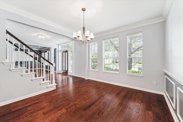 interior space featuring a notable chandelier, baseboards, hardwood / wood-style floors, and a healthy amount of sunlight
