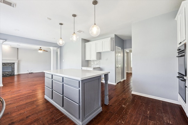 kitchen with gray cabinetry, visible vents, and white cabinetry