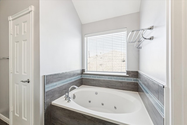 full bathroom featuring a jetted tub
