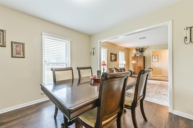 18210 Point Lookout Dr, Houston, TX 77058 - dining room with dark wood-style flooring, healthy amount of natural light, and baseboards