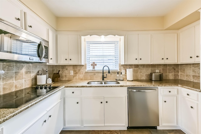 18210 Point Lookout Dr, Houston, TX 77058 - kitchen featuring appliances with stainless steel finishes, a sink, and white cabinets