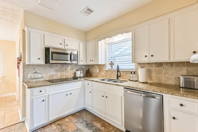 18210 Point Lookout Dr, Houston, TX 77058 - kitchen with appliances with stainless steel finishes, a sink, tasteful backsplash, and white cabinetry