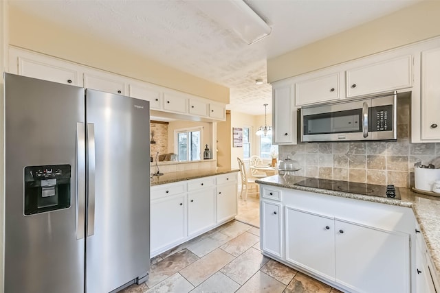 18210 Point Lookout Dr, Houston, TX 77058 - kitchen featuring appliances with stainless steel finishes, decorative backsplash, white cabinets, light stone counters, and a textured ceiling