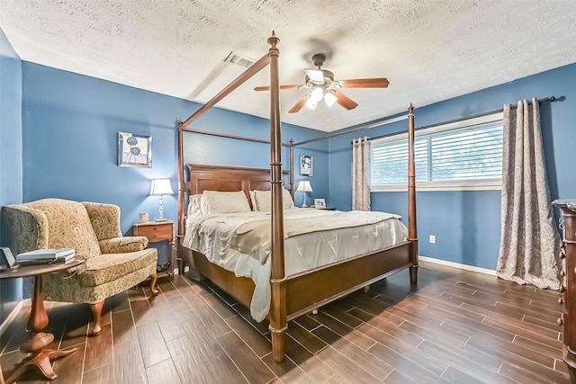 18210 Point Lookout Dr, Houston, TX 77058 - bedroom with a textured ceiling, wood finished floors, baseboards, and a ceiling fan
